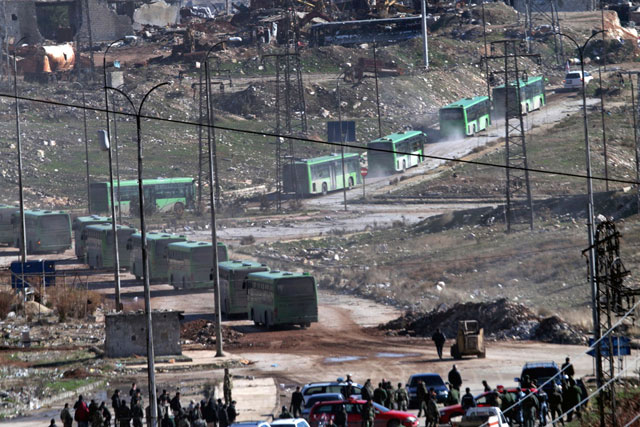 In this photo released by the Syrian official news agency SANA, green government buses carry residents evacuating from eastern Aleppo, Syria, Thursday (AP photo)