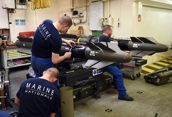 French navy soldiers work on missiles aboard the French Charles de Gaulle aircraft carrier, on Sunday, in the eastern Mediterranean Sea (AFP photo)