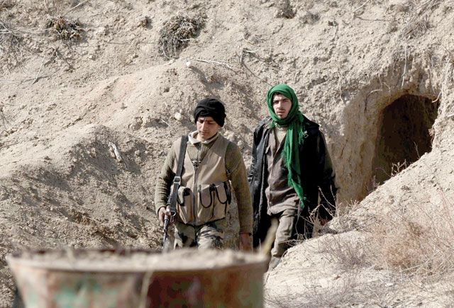 Opposition fighters walk out of a tunnel in Tal Al Aswan in the area of the eastern Ghouta rebel bastion east of the Syrian capital, Damascus, during clashes with government forces on Tuesday (AFP photo)