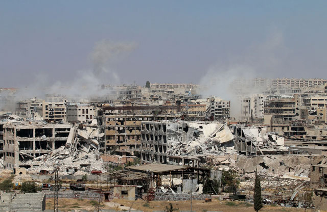 Smoke billows from buildings during an operation by Syrian government forces to retake control of the rebel-held district of Leramun, on the northwest outskirts of Aleppo, on Tuesday (AFP photo)