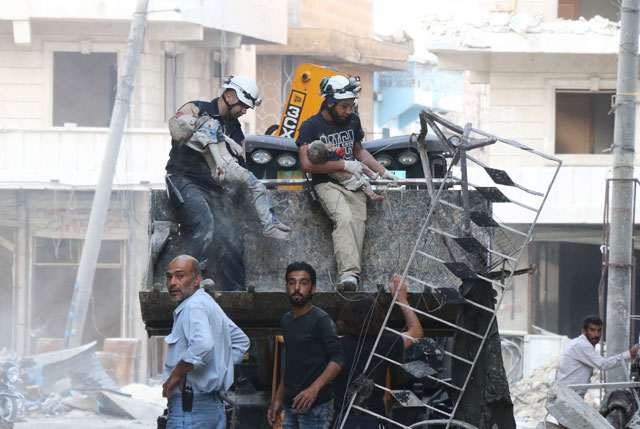 Syrian emergency personnel carry the bodies of children after removing them from the rubble of a damaged building following reported air strikes on Thursday, in Aleppo's rebel-held neighbourhood of Tariq Al Bab (AFP photo)