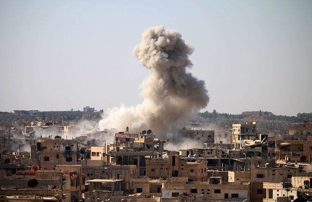 Smoke billows following an air strike by Syrian government forces in a rebel-held area of Daraa on Wednesday (AFP photo)