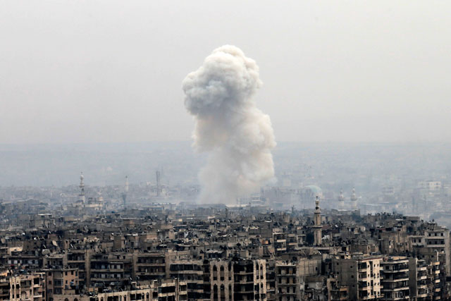 Smoke rises following a reported Syrian government air strike on rebel positions, in eastern Aleppo, Syria, Monday (AP photo)