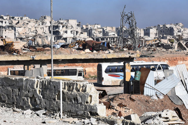 Empty buses that are going to be used to evacuated Syrians from eastern Aleppo enter the embattled city through the Ramoussa crossing, on the southern outskirts of Aleppo, on Tuesday. Syria’s army urged the last remaining rebels and civilians to leave the bombed-out eastern quarters of Aleppo as it prepares to take full control of the devastated city (AFP photo)