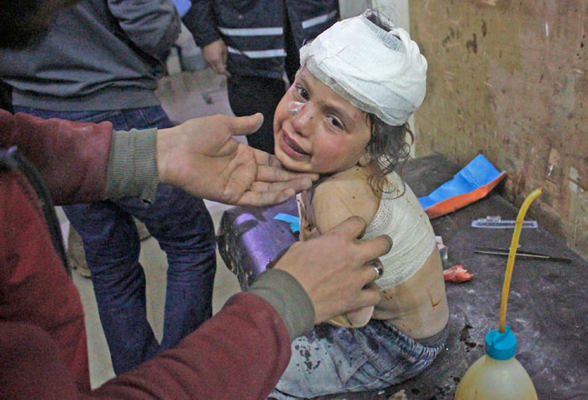 An injured child receives treatment at a military hospital after an air strike, which left 6 children dead and 8 civilians injured at a farm where Syrians sheltered in Idlib, northeast of Syria, on Sunday (Anadolu Agency photo)