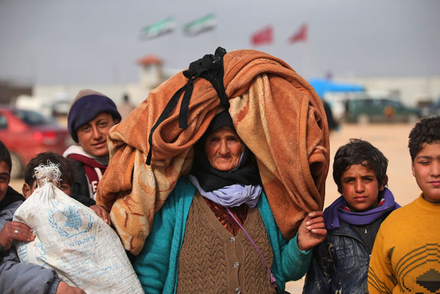 Syrians, some carrying belongings, head towards the Bab Al Salama border crossing with Turkey, in Syria, on Saturday. Thousands of Syrians have rushed towards the Turkish border, fleeing fierce Syrian government offensives and intense Russian air strikes (AP photo)