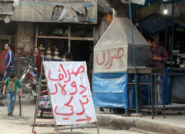 A sign for a money exchange office is seen along a street in a rebel-controlled area of Aleppo, Syria, on Wednesday (Reuters photo)