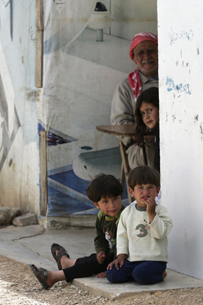 Syrian refugee children sit with their grandfather at an unofficial refugee camp in Lebanon's town of Bar Elias in the Bekaa Valley on May 13 (AFP photo)