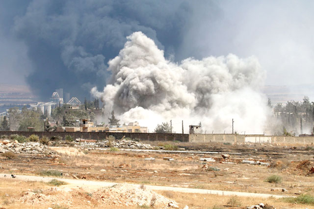 Smoke billows following air strikes by regime forces on rebel positions during intense fighting in Aleppo on Thursday (AFP photo by George Ourfalian)