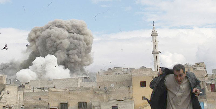 In this February 27, 2014, file photo, provided by the anti-government activist group Aleppo Media Centre, which has been authenticated based on its contents and other AP reporting, shows a Syrian man (right) runs for cover from a Syrian government forces air strike attack in Aleppo, Syria (AP photo)