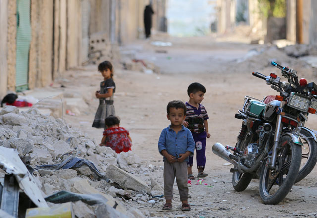 Children play along a street in the rebel-held Al Sheikh Said neighbourhood of Aleppo, Syria, on Friday (Reuters photo)