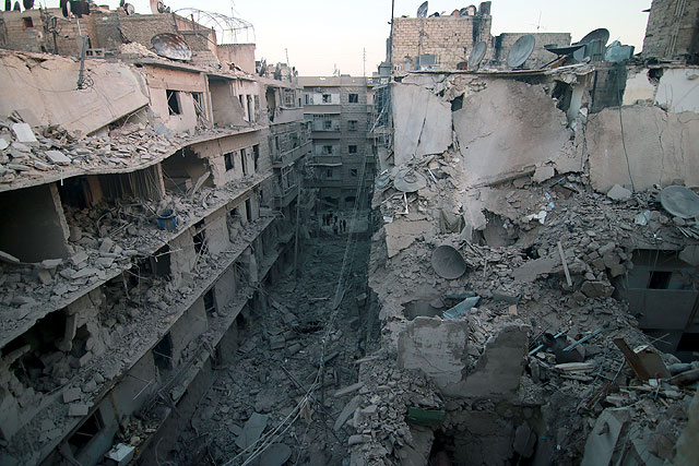 Destroyed buildings are seen after air strikes reportedly carried out by Russian warplanes over the opposition controlled town of Bustan Al Qasr in Aleppo, Syria, on Tuesday (Anadolu Agency photo)