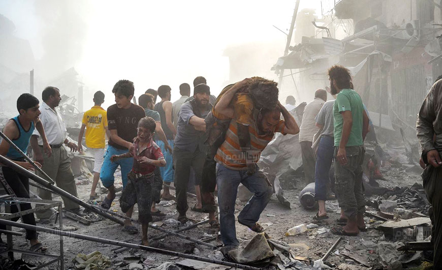 In this photo provided by the Syrian anti-government activist group Ariha Today, which has been authenticated based on its contents and other AP reporting, Syrian citizens help an injured boy as another carries a man after a government forces warplane crashed in the center of Ariha town in the northwestern province of Idlib, Syria, Monday (AP photo)