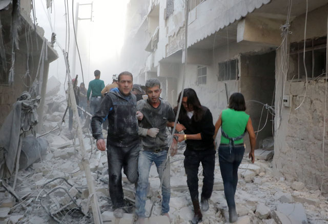 Wounded people are seen around the wreckage of buildings after the aircraft reportedly belonging to the Russian Army carried out an air strike on a residential area in Aleppo, on Tuesday (Anadolu Agency photo)