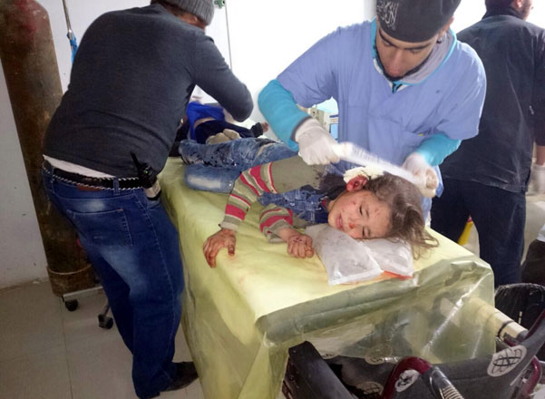 A wounded kid receives medical treatment after warplanes reportedly belonging to the Assad regime carried out an air strike over opposition controlled residential areas in Binnis district of Idlib, Syria, on Thursday (Anadolu Agency photo)