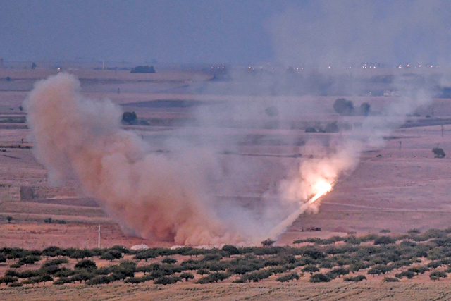 This photo taken on Wednesday shows a missile fired by Turkish forces towards the Syrian town of Ras Al Ain, from the Turkish side of the border at Ceylanpinar district in Sanliurfa on the first week of Turkey’s military operation against Kurdish forces  (AFP photo)