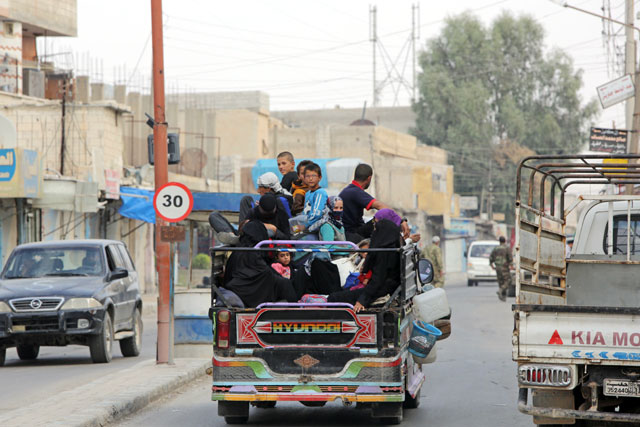 Displaced Syrians flee the border town of Tal Abyad, towards Raqqa, on Thursday (AFP photo)