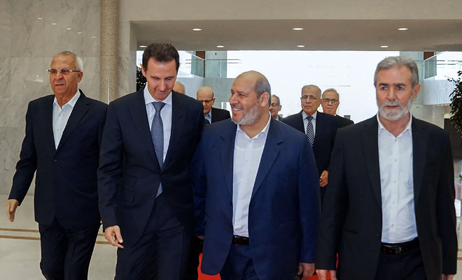 This handout photo released by the Syrian Presidency shows Syria’s President Bashar Assad (second left) receiving the leader of Palestinian group Islamic Jihad, Ziad Al Nakhala (right) Hamas chief of Arab relations, Khalil Al Hayya (second right) and secretary general of the Popular Front for the Liberation of Palestine, Talal Naji (left), in the capital Damascus, on Wednesday (AFP photo)