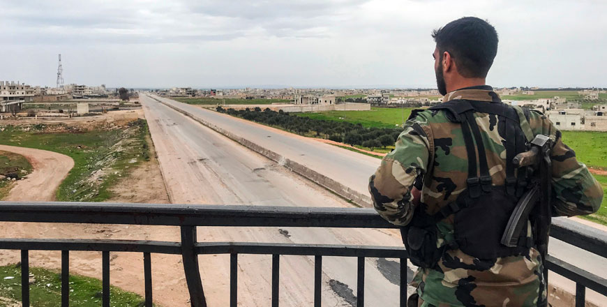 A Syrian army soldier stands overlooking a motorway in the town of Saraqib in the northwestern Idlib province on Friday, as government forces assumed control over it (AFP photo)
