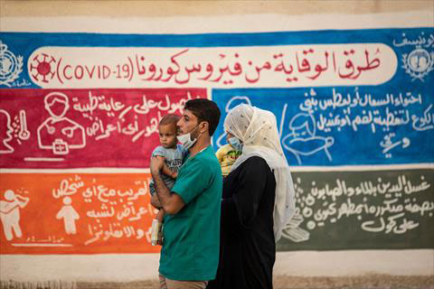 Syrians walk past a mural painted as part of an awareness campaign by the United Nations International Children's Emergency Fund (UNICEF) and World Health Organisation (WHO), bearing instructions on protection from COVID-19 in the Kurdish-majority city of Qamishli of Syria's northeastern Hasakeh province on Sunday (AFP photo)