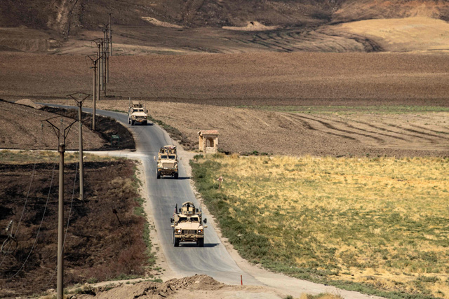 A US military convoy patrols near the Rumaylan (Rmeilan) oil fields in Syria’s Kurdish-controlled northeastern Hasakeh province, on Thursday  (AFP photo)