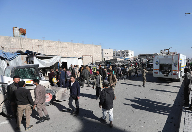 People gather at the scene of a car bomb in the Turkish-controlled town of Al Bab in the north of Syria's Aleppo province on Tuesday (AFP photo)