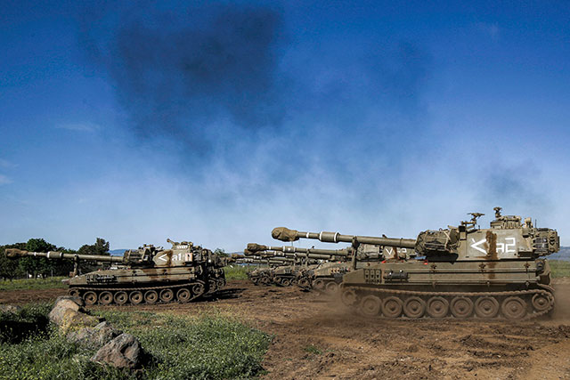 Mobile artillery cannons group at a position in the Israeli-annexed Golan Heights on Thursday (AFP photo)