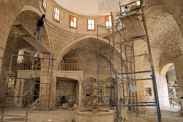 An historic building undergoes restoration in the ‘Souq Al Habil’ (ropes market) in Syria's northern city of Aleppo, on Monday (AFP photo)