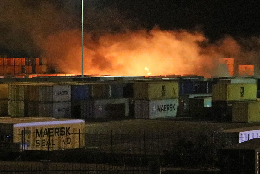 A photo released by the official Syrian Arab News Agency on Tuesday shows fire near containers of the Syrian port of Latakia (AFP photo)