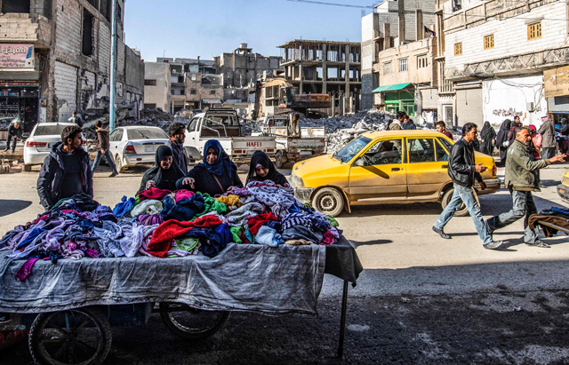 Women choose second hand clothing , in a market street in the northern city of Raqqa on Sunday (AFP photo)