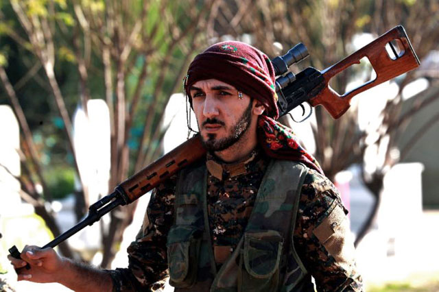 A fighter from the Syrian Democratic Forces attends the funeral of a comrade killed in the town of Hajin during battles against the Daesh group, in the northeastern city of Qamishli, on Monday (AFP photo)