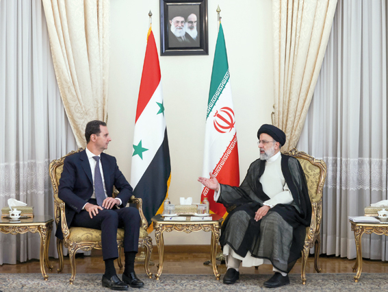 This handout photo provided by the Iranian presidency on Sunday shows Iranian President Ebrahim Raisi (right) receiving Syrian President Bashar Assad in the capital Tehran (AFP photo)