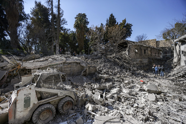 People inspect damage in the aftermath of an Israeli air strike that hit the mediaeval Citadel of Damascus on Sunday (AFP photo)