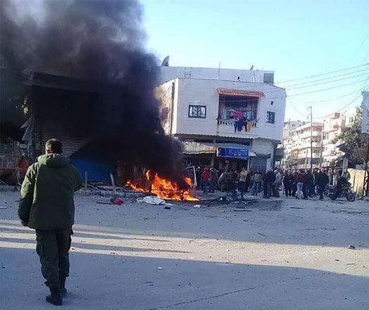 This handout image, made available by state news agency SANA’s Telegram page, shows people gathering around a burning vehicle in the Syrian regime’s coastal stronghold of Latakia, on Tuesday (AFP photo)