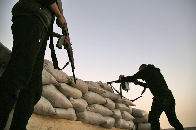 Turkish-backed Syrian fighters take up an armed position with sandbags on the frontline with SDF forces near the village of Kiridiyah, about 30km west of the northern town of Manbij, on January 15 (AFP photo)