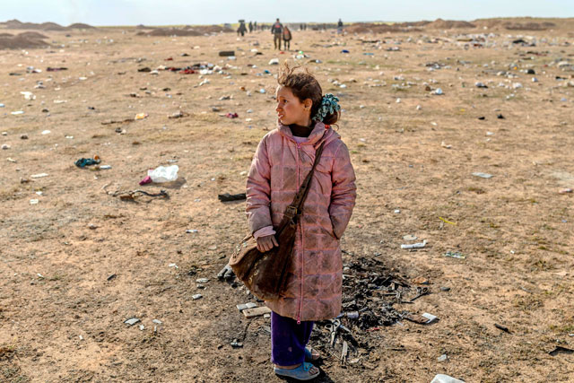 A girl stands alone as women and children evacuated from Daesh embattled holdout of Baghouz arrive at a screening area held by the US-backed Kurdish-led Syrian Democratic Forces, in the eastern Syrian province of Deir Ezzor, on Tuesday  (AFP photo)