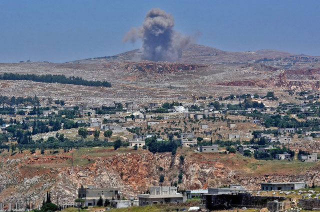 This photo taken on Friday from the Syrian town of Qalaat Al Madiq, some 45 kilometres northwest of the central city of Hama, shows bombardment by Syrian government forces on the Shashabo Mountain (AFP photo)