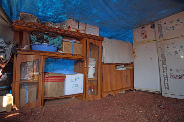 Fridges and other appliances of displaced Syrian families are stored in a tent to protect them from the elements in a field near a camp for displaced people at the village of Atme, in the northern Idlib province, on June 13 (AFP photo)
