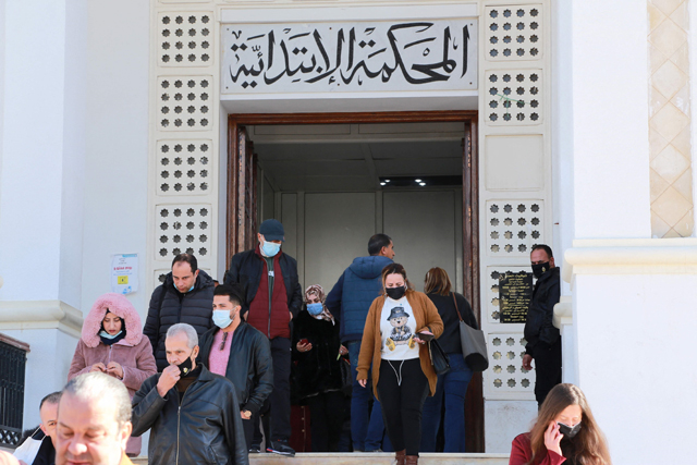 Tunisian citizens and lawyers leave the court of the governorate of Ariana after the announcement of a strike of the judges on Wednesday following the dissolution of the supreme council of the Judiciary by President Saied (AFP photo)