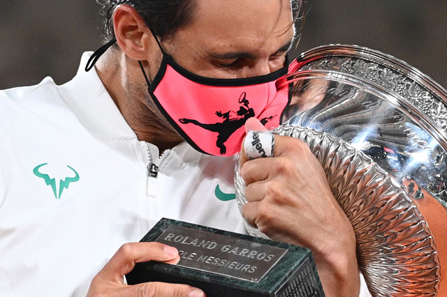Spain's Rafael Nadal kisses the Mousquetaires Cup (The Musketeers) as he celebrates after winning the men's singles final match against Serbia's Novak Djokovic at the Philippe Chatrier Court on Day 15 of The Roland Garros 2020 French Open tennis tournament in Paris on Sunday (AFP photo by Anne-Christine Poujoulat)