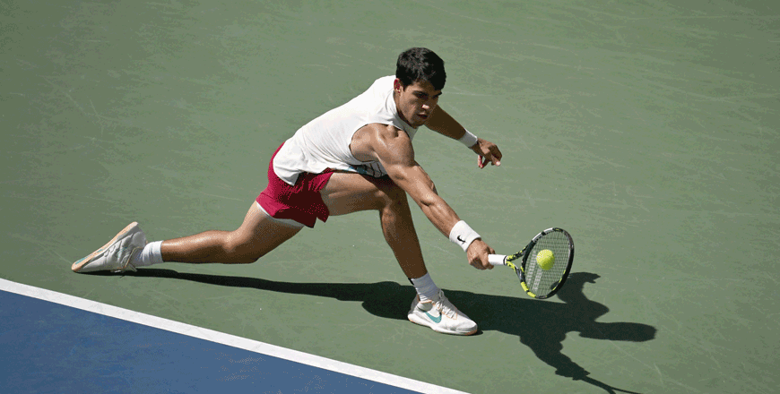 Spain's Carlos Alcaraz hits a return to Britain's Daniel Evans during their US Open tennis tournament men's singles third round match at the USTA Billie Jean King National Tennis Centre in New York City, on Saturday (AFP photo)