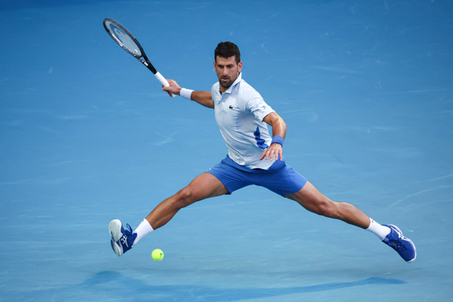 Serbia’s Novak Djokovic hits a return against USA’s Taylor Fritz during their men’s singles quarter-final match on day 10 of the Australian Open tennis tournament in Melbourne on Tuesday (AFP photo)