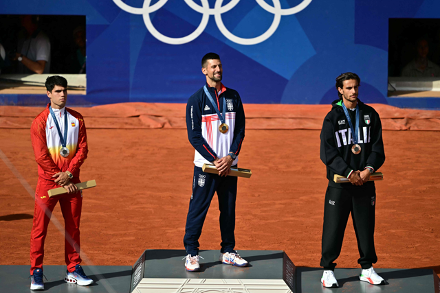From left to right:  Silver medallist Spain’s Carlos Alcaraz, gold medallist, Serbia’s Novak Djokovic and bronze medallist Italy’s Lorenzo Musetti pose with their medals on the podium on Court Philippe-Chatrier at the Roland-Garros Stadium during the Paris 2024 Olympic Games, on Sunday (AFP photo)