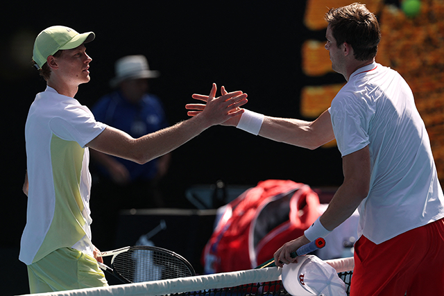 Italy's Jannik Sinner (left) shakes hands with Chile's Nicolas Jarry after their men's singles match on day two of the Australian Open tennis tournament in Melbourne on Monday (AFP photo)