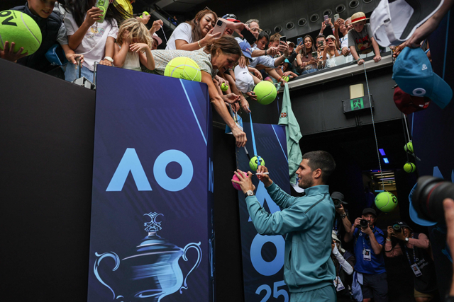 Spain's Carlos Alcaraz signs autogtaphs after victory against Japan's Yoshihito Nishioka during their men's singles match on day four of the Australian Open tennis tournament in Melbourne on Wednesday (AFP photo)