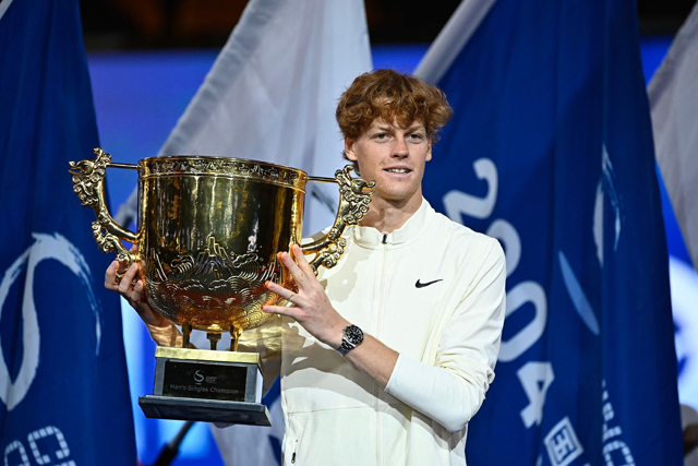 Italy's Jannik Sinner holds the winning trophy after defeating Russia’s Daniil Medvedev in the men's singles final match during the China Open tennis tournament in Beijing on Wednesday (AFP photo)