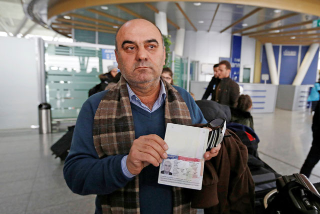 Fuad Sharef Suleman shows his USA visa to the media after returning to Iraq from Egypt, where he was prevented from boarding a plane to the US at Erbil International Airport, Iraq, on Sunday (Reuters photo by Ahmed Saad)