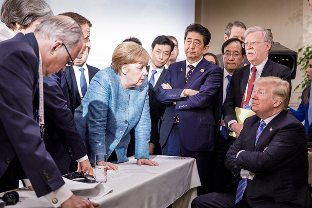 This photo released on Twitter by the German government’s spokesman Steffen Seibert on Saturday  and taken by the German government’s photographer Jesco Denzel shows US President Donald Trump (right) talking with German Chancellor Angela Merkel (centre) and surrounded by other G-7 leaders during a meeting of the G-7 summit in La Malbaie, Quebec, Canada (AFP PHOTO)
