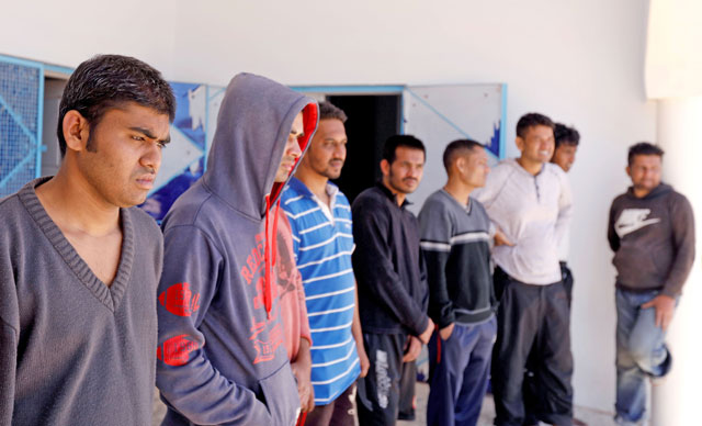 Migrants, who were rescued after their boat capsized in the Mediterranean Sea off the Tunisian coast after they had left Libya, are seen inside a local Red Crescent chapter in Zarzis, Tunisia, on Saturday (Reuters photo)
