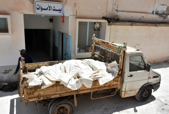 Forensic workers load into a truck the bodies of African migrants, who were recovered on the Tunisian coast and will be buried at a communal cemetery in El Ketif near the eastern coastal city of Zarzis, outside the Gabes hospital morgue, on July 17 (AFP photo)